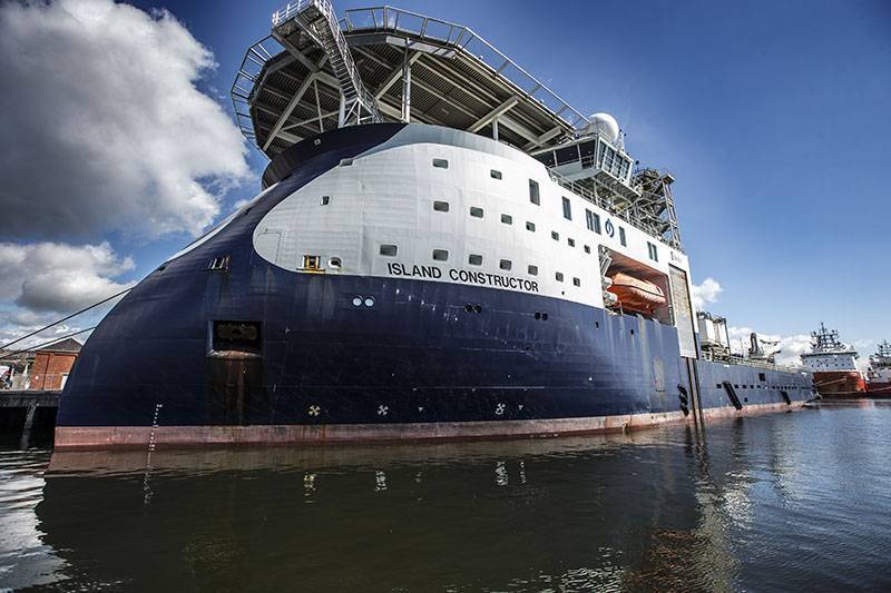 Navy and white Island Constructor vessel at Forth Ports Dundee
