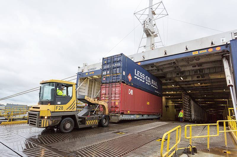 a tug discharging a container double stack from a Ro-Ro ferry