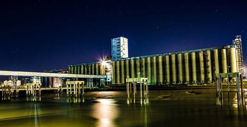 the Grain Terminal at Port of Tilbury at night, viewed from the River Thames